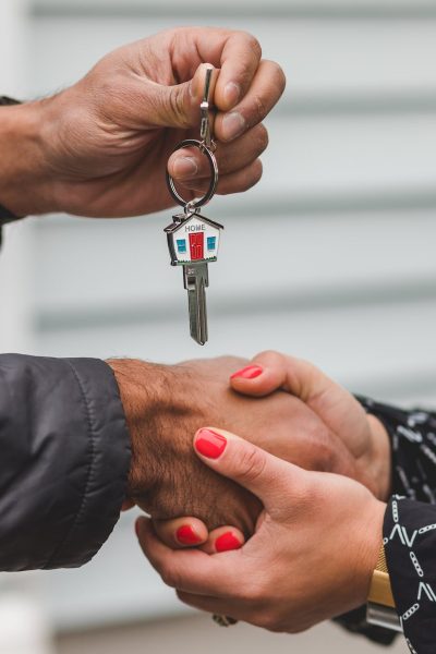 person holding silver key